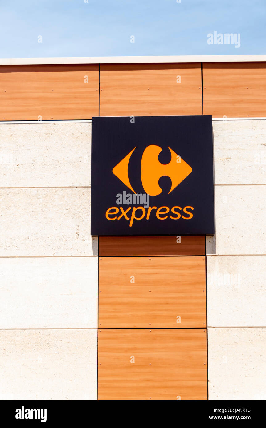 The logo of Carrefour express supermarket on the side of a French convenience store. Stock Photo