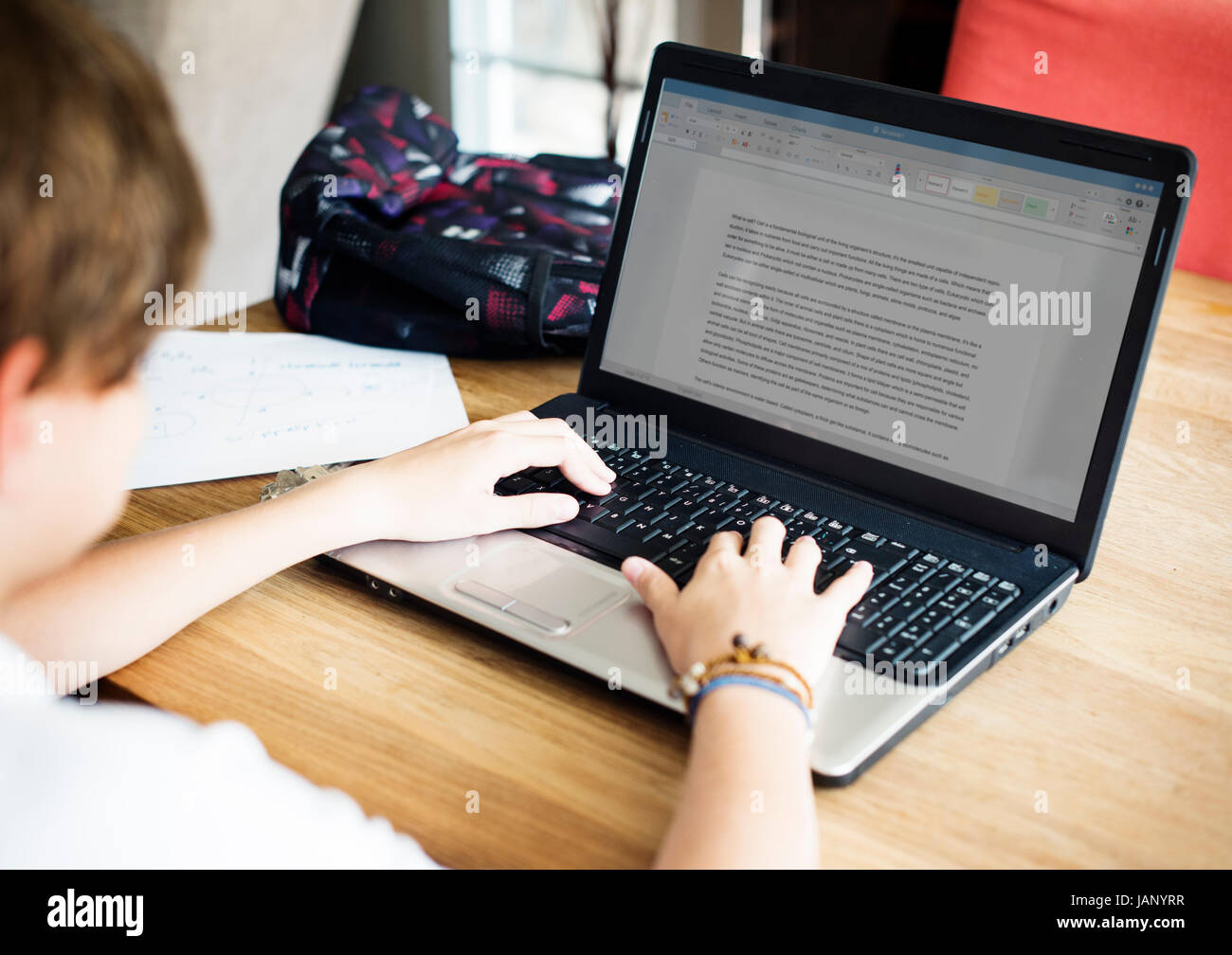 Young caucasian boy doing homework with computer laptop Stock Photo Alamy