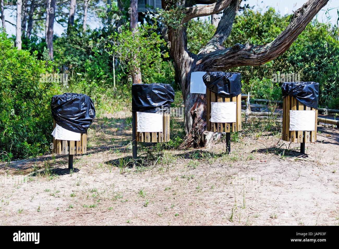 four recycle bins in a park Stock Photo - Alamy
