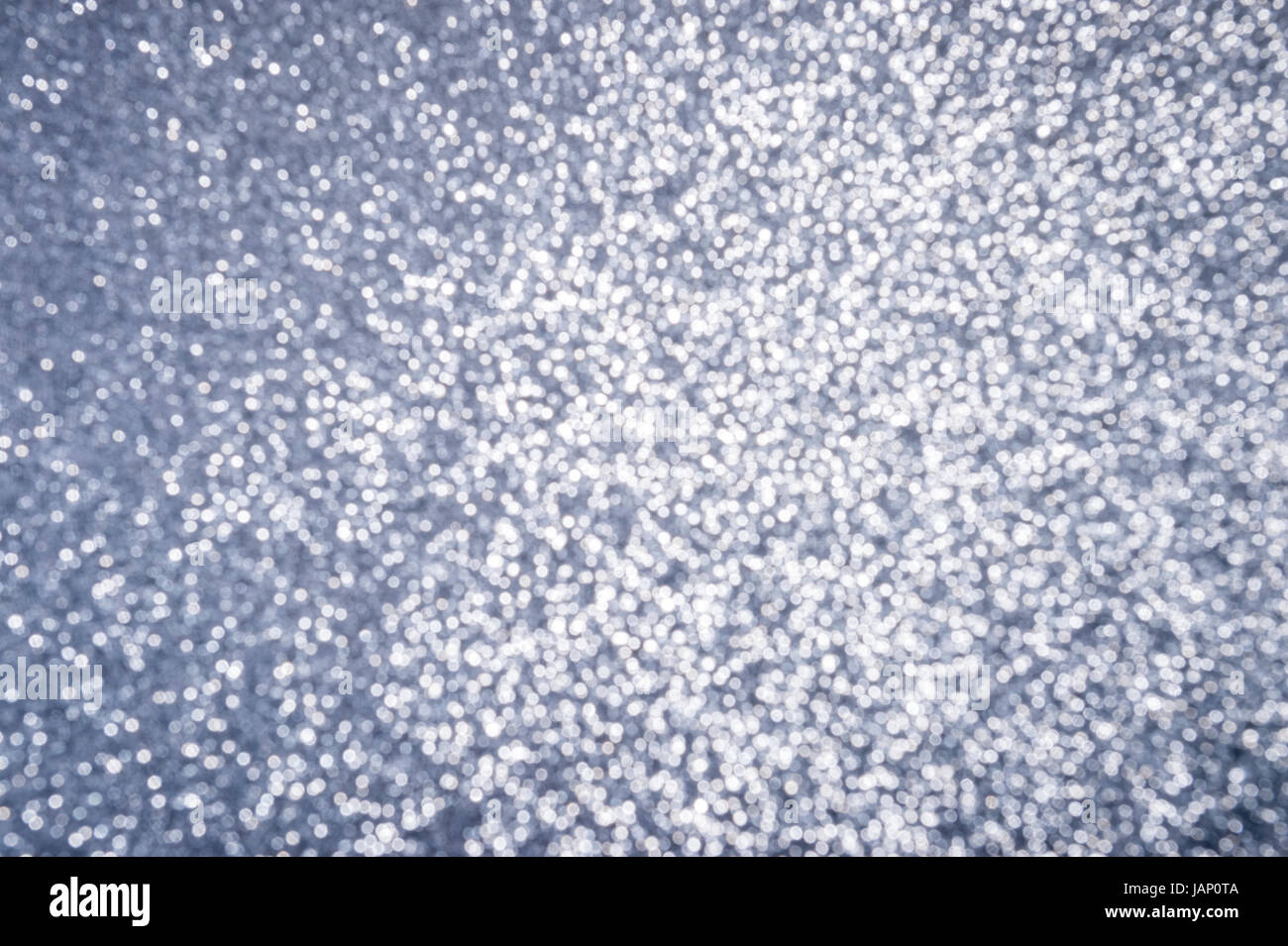 Silver glitter bokeh background in defocus abstract Stock Photo