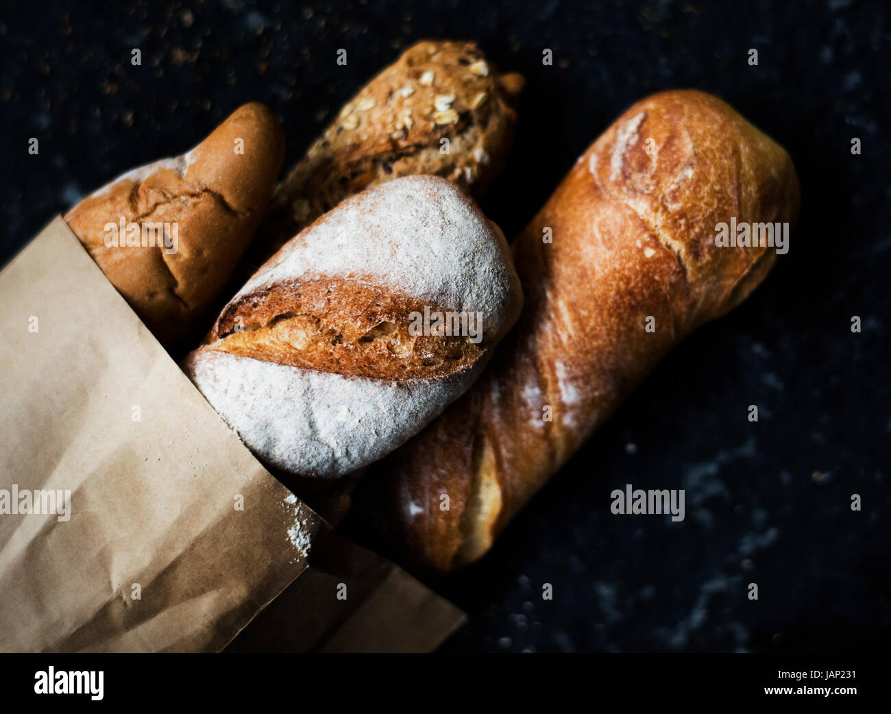 Baguettes on paper bag with black background Stock Photo - Alamy