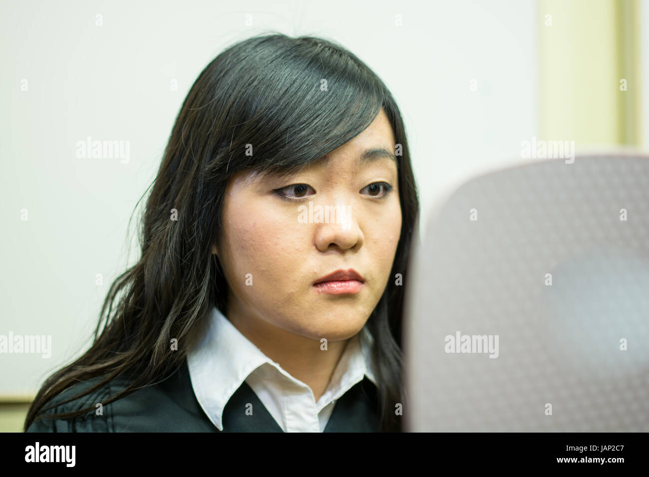 Young woman checking herself in the mirror Stock Photo Alamy
