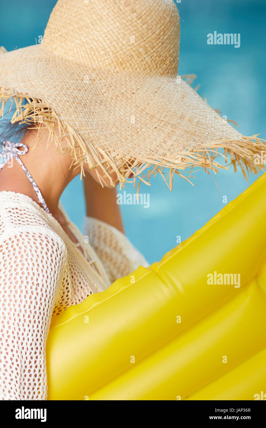 Slim Girl with inflatable mattress next pool in garden. Summer concept Stock Photo