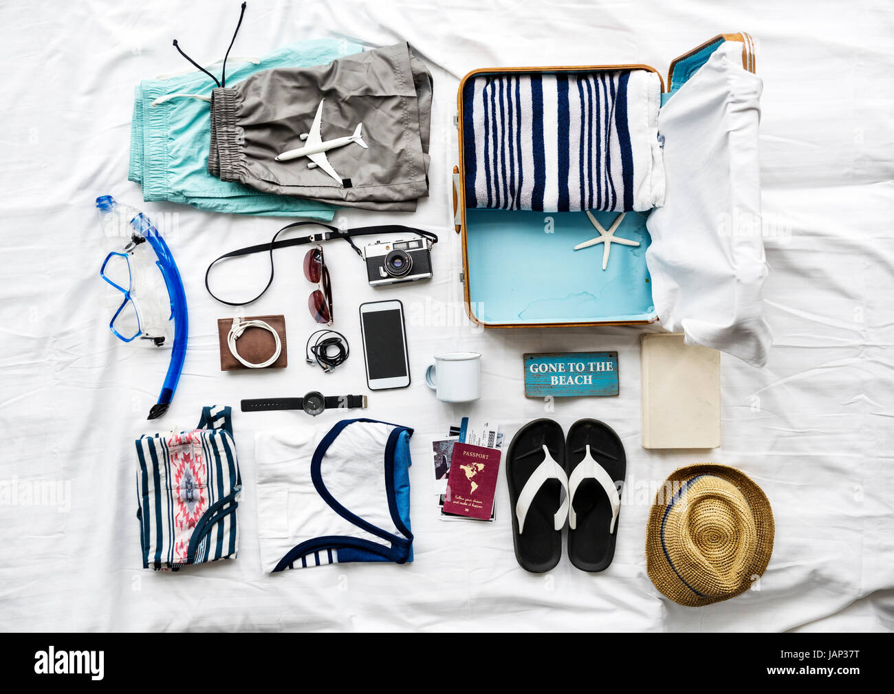 Aerial view of clothes preparing to pack on bed Stock Photo