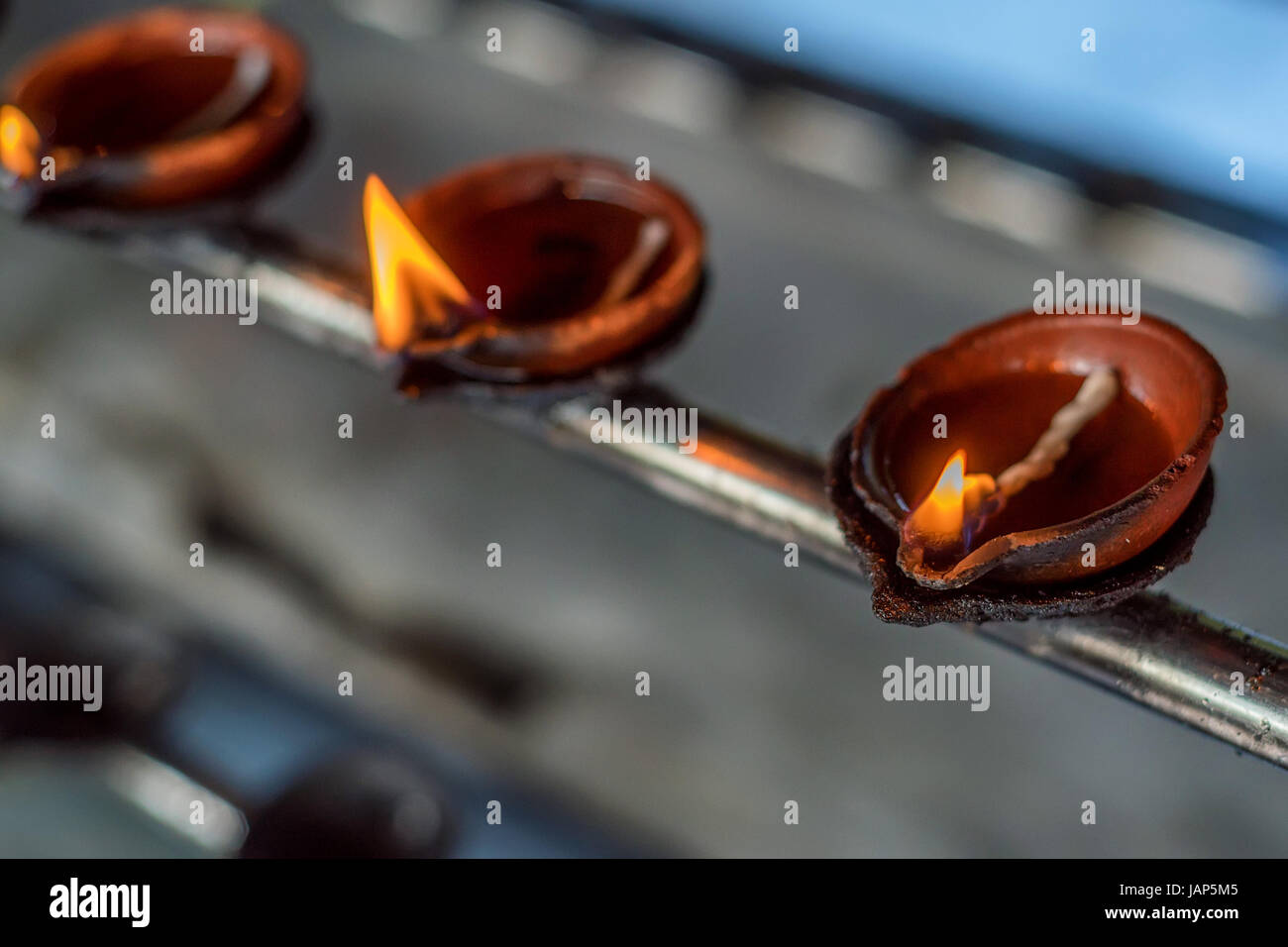 Coconut oil lamps for sacred fire in Buddha Tooth Relic Temple in Kandy