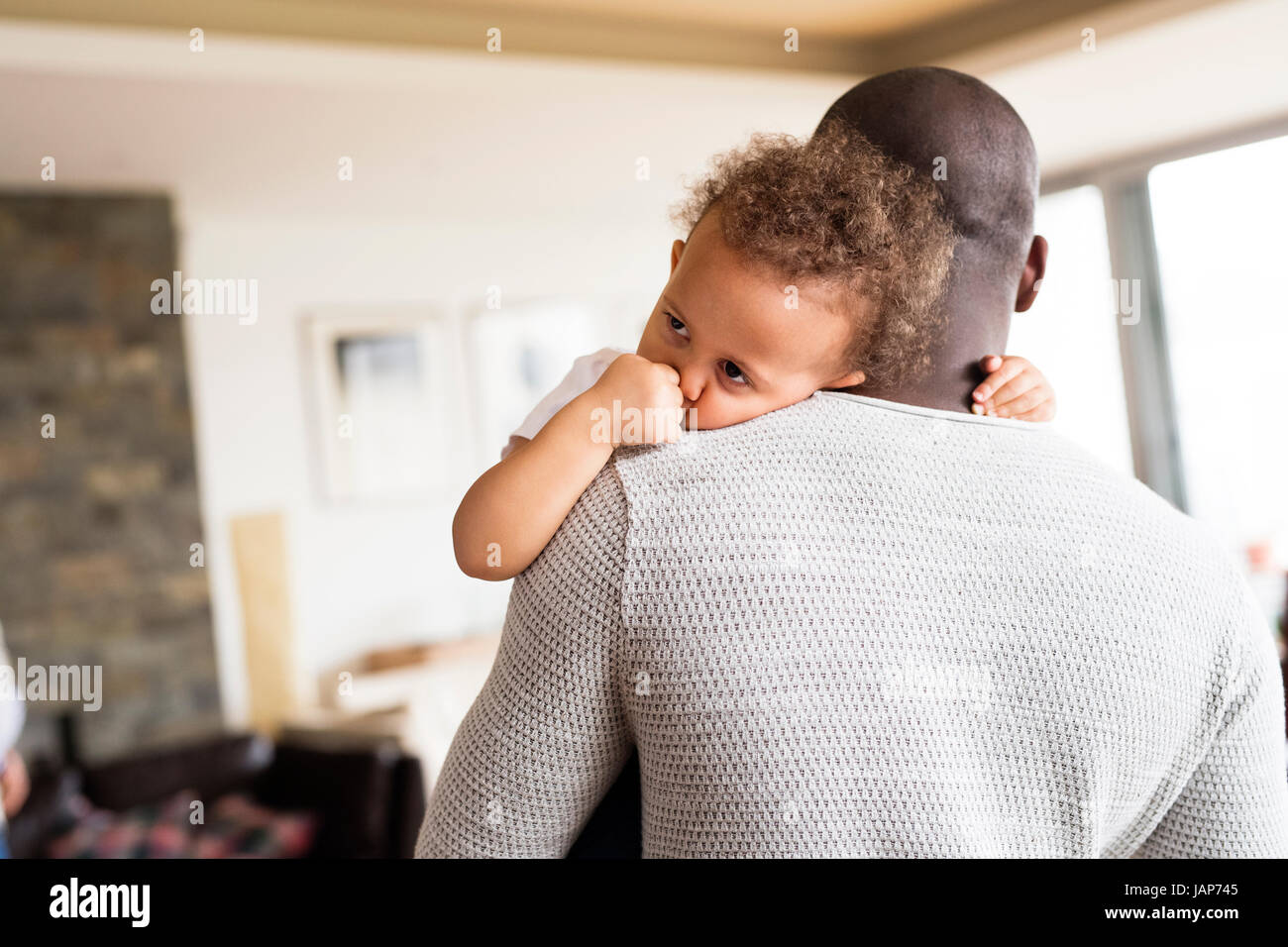 Unrecognizable afro-american father holding his little daughter Stock Photo