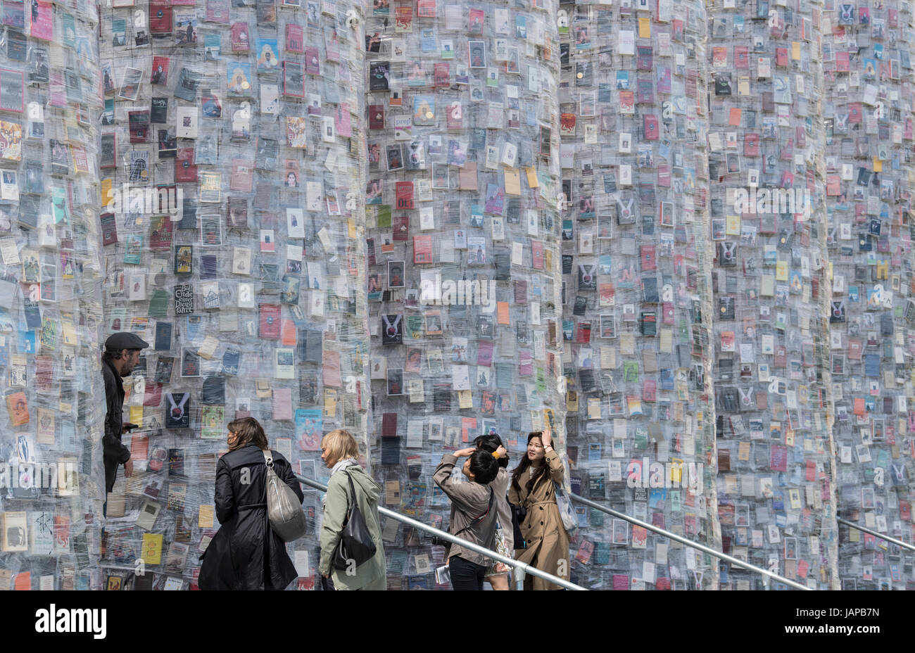 Visitors look at Argentinian conceptual artist Marta Minujin's work 'The Parthenon of Books' in Kassel, Germany, 7 June 2017. The work, a temple constructed using hundreds of thousands of books, is the show-piece at this year's documenta 14 art festival. The festival will officially open on the 10 June 2017. Photo: Boris Roessler/dpa Stock Photo