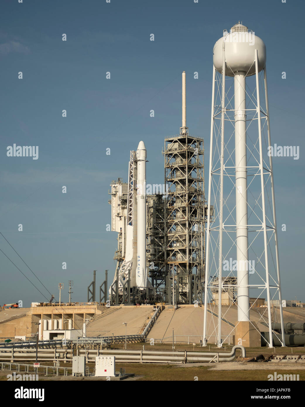 The SpaceX Falcon 9 rocket, with the Dragon spacecraft onboard, is seen shortly after being raised vertical at Launch Complex 39A at NASA·s Kennedy Space Center in Cape Canaveral, Florida, Thursday, June 1, 2017. Dragon is carrying almost 6,000 pounds of science research, crew supplies and hardware to the International Space Station in support of the Expedition 52 and 53 crew members. The unpressurized trunk of the spacecraft also will transport solar panels, tools for Earth-observation and equipment to study neutron stars. This will be the 100th launch, and sixth SpaceX launch, from this pad. Stock Photo