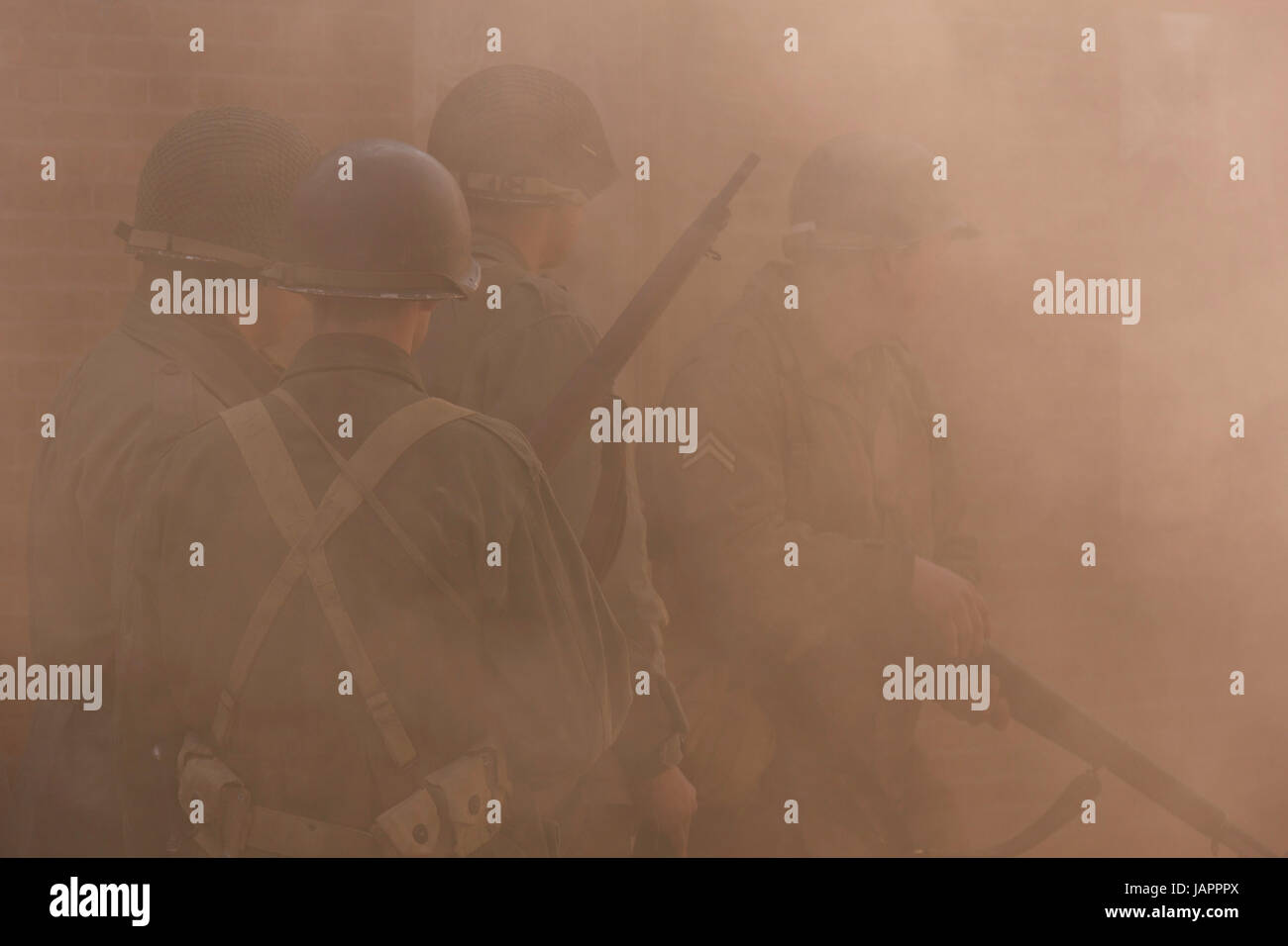 Spijk terug naar toen event:US soldiers covered by orange smoke Stock Photo