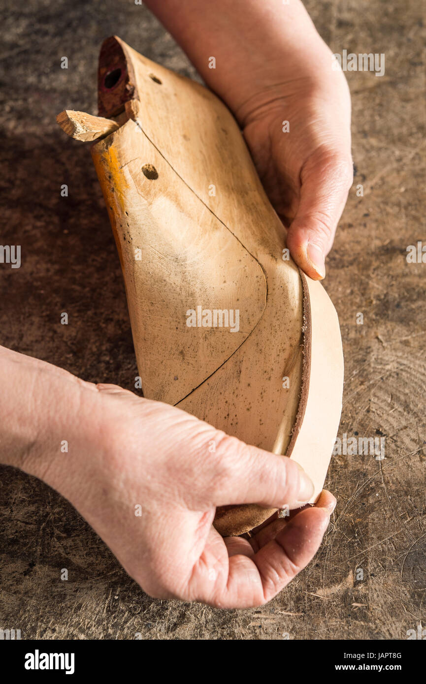 Shoemaker, hands holding a piece of leather on a shoe last, Kainisch, Styria, Austria Stock Photo
