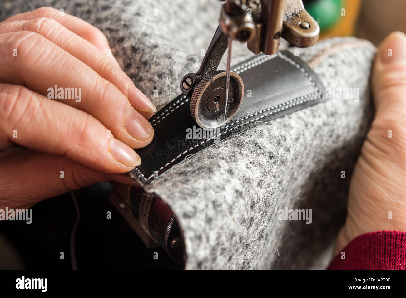 Shoemaker, hands stitching cuttings, felt, leather, fur, Kainisch, Styria, Austria Stock Photo