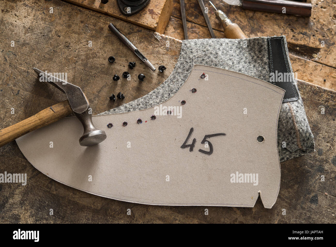 Shoemaker, stencil with felt part, besides hammer and Eyelet setter,  eyelets, hook, on wooden panel, Kainisch, Styria, Austria Stock Photo -  Alamy