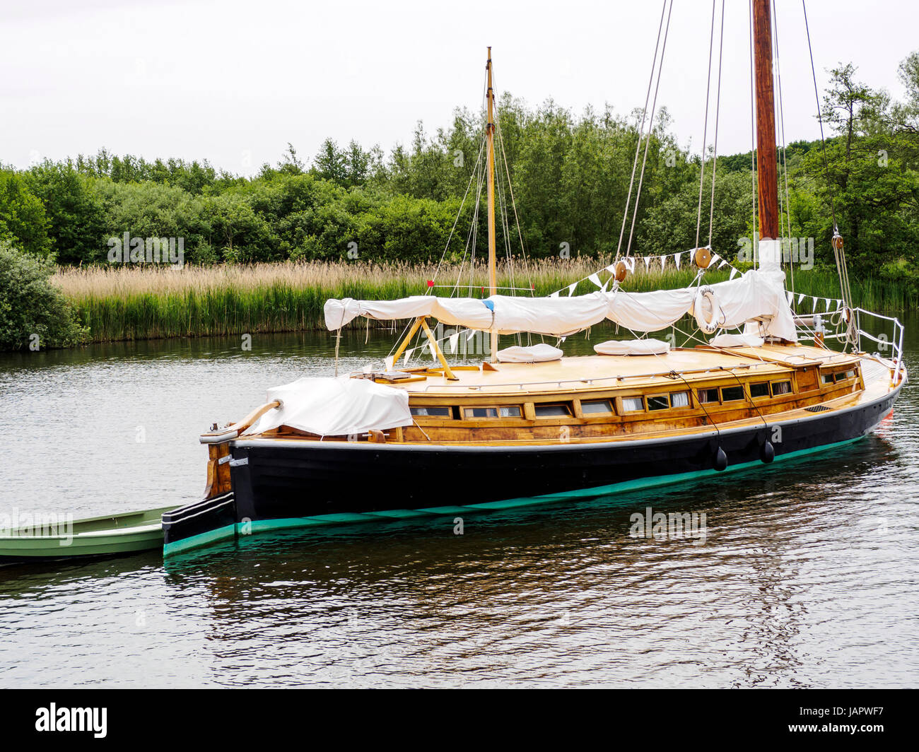 The Norfolk wherry 'Solace', now converted to a luxury yacht and moored on Wroxham Broad, Norfolk. Stock Photo