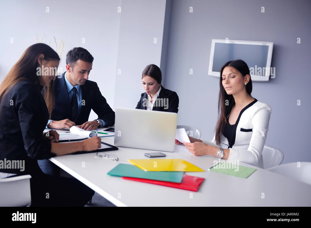 Group of happy young business people in a meeting at office Stock Photo ...