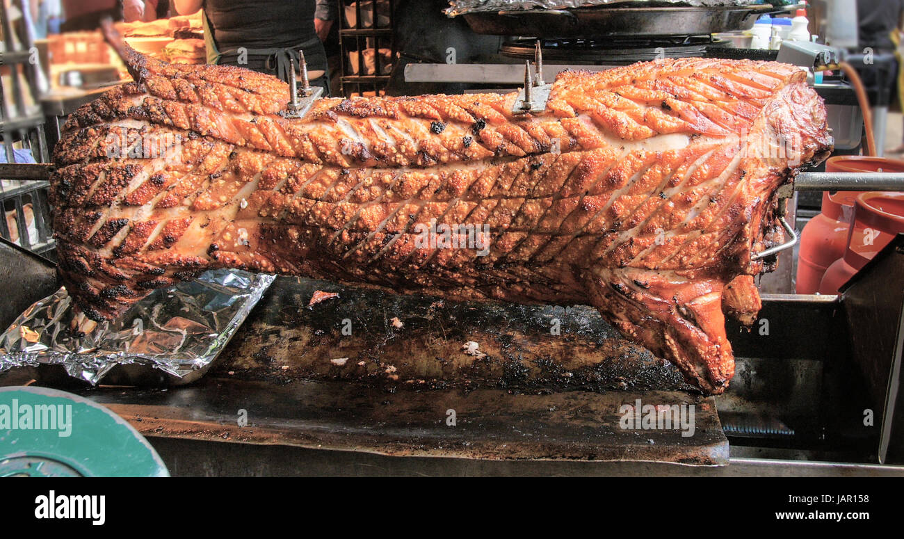 Whole pork slow cooked on a barbecue Stock Photo