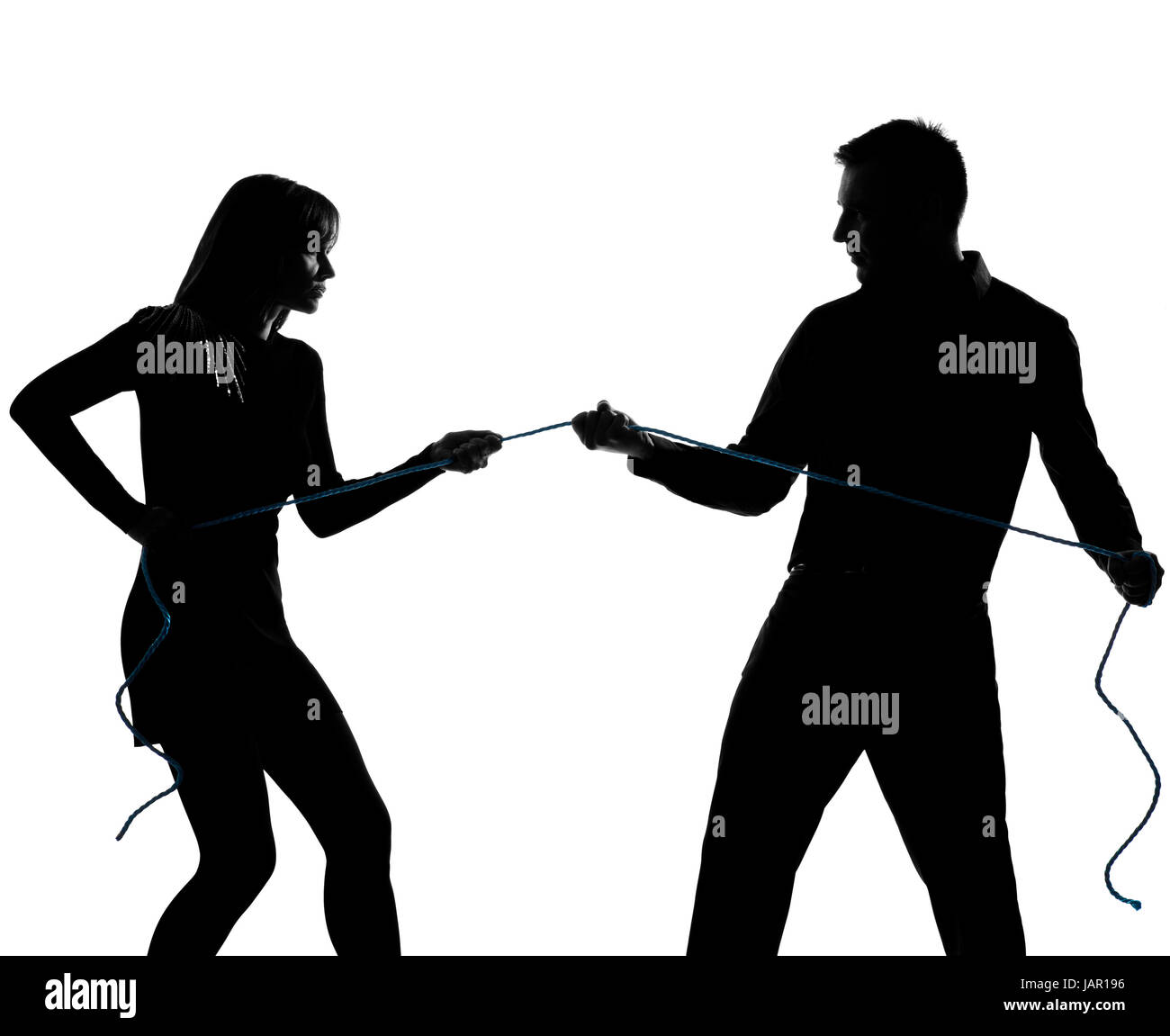 one caucasian couple man and woman pulling a rope in studio silhouette