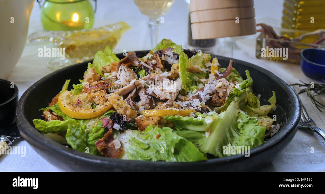 Sprinkling black pepper over a delicious Caesar&amp;#39;s salad Stock Photo - Alamy