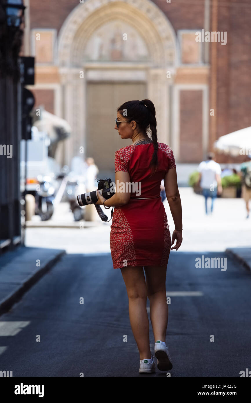 Woman in red dress and camera Stock Photo