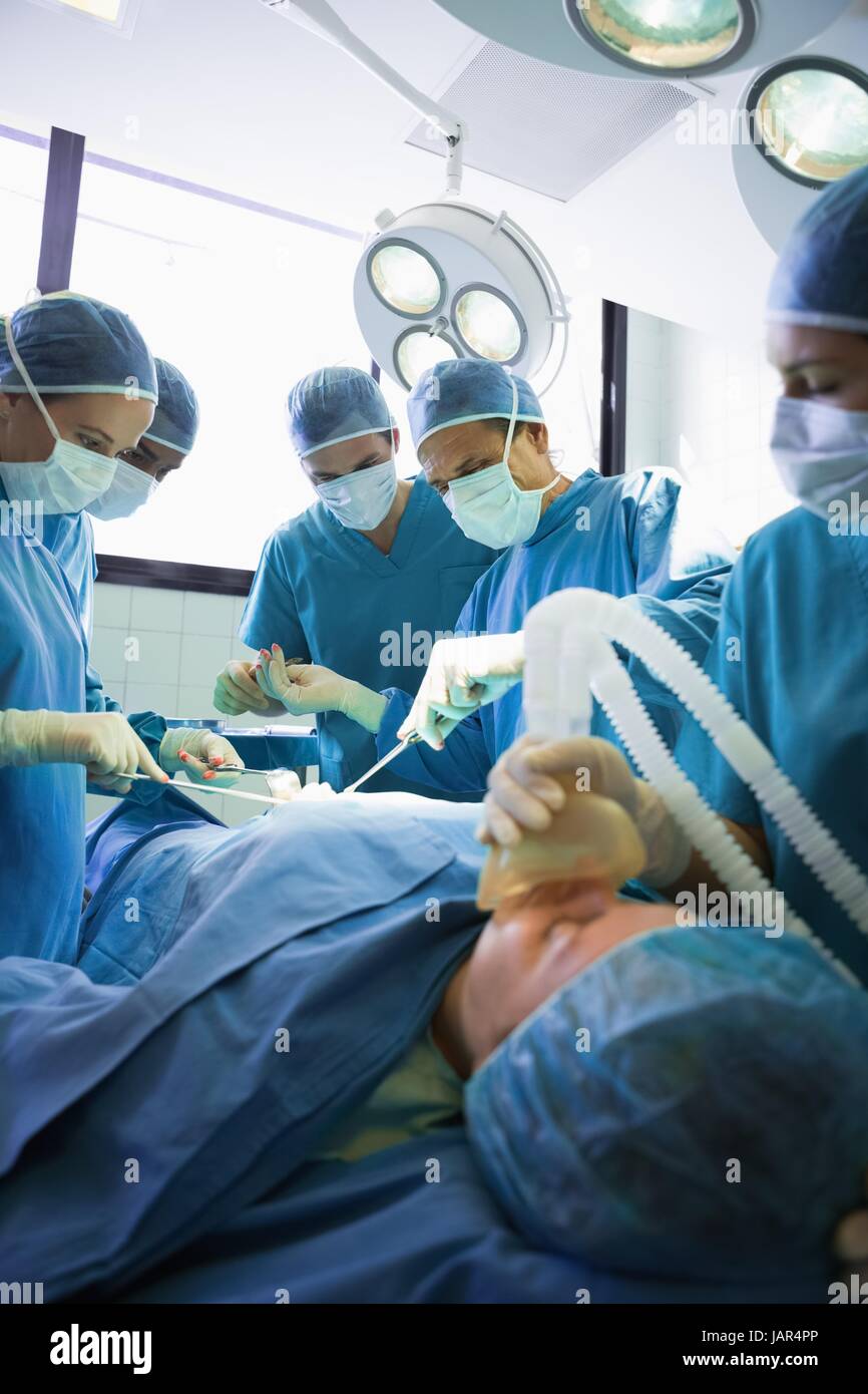 Operation being performed by a group of surgeons Stock Photo