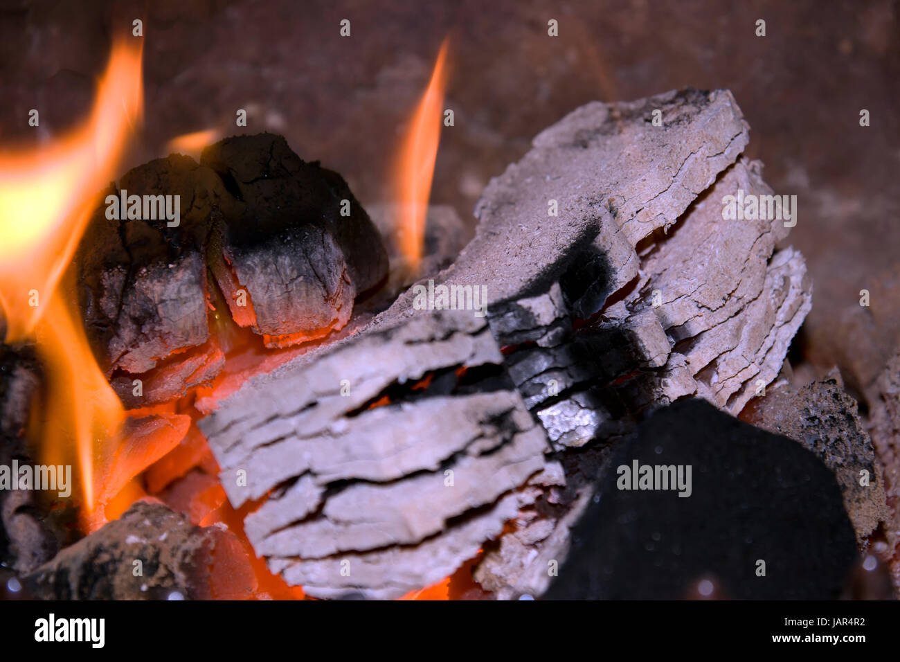 peat briquettes burning in a red and white hot fire Stock Photo