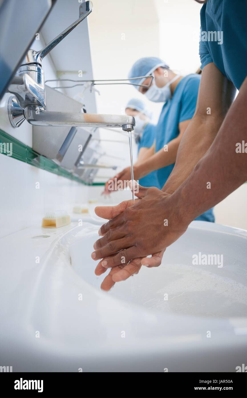 Surgeons washing their hands with masks Stock Photo Alamy