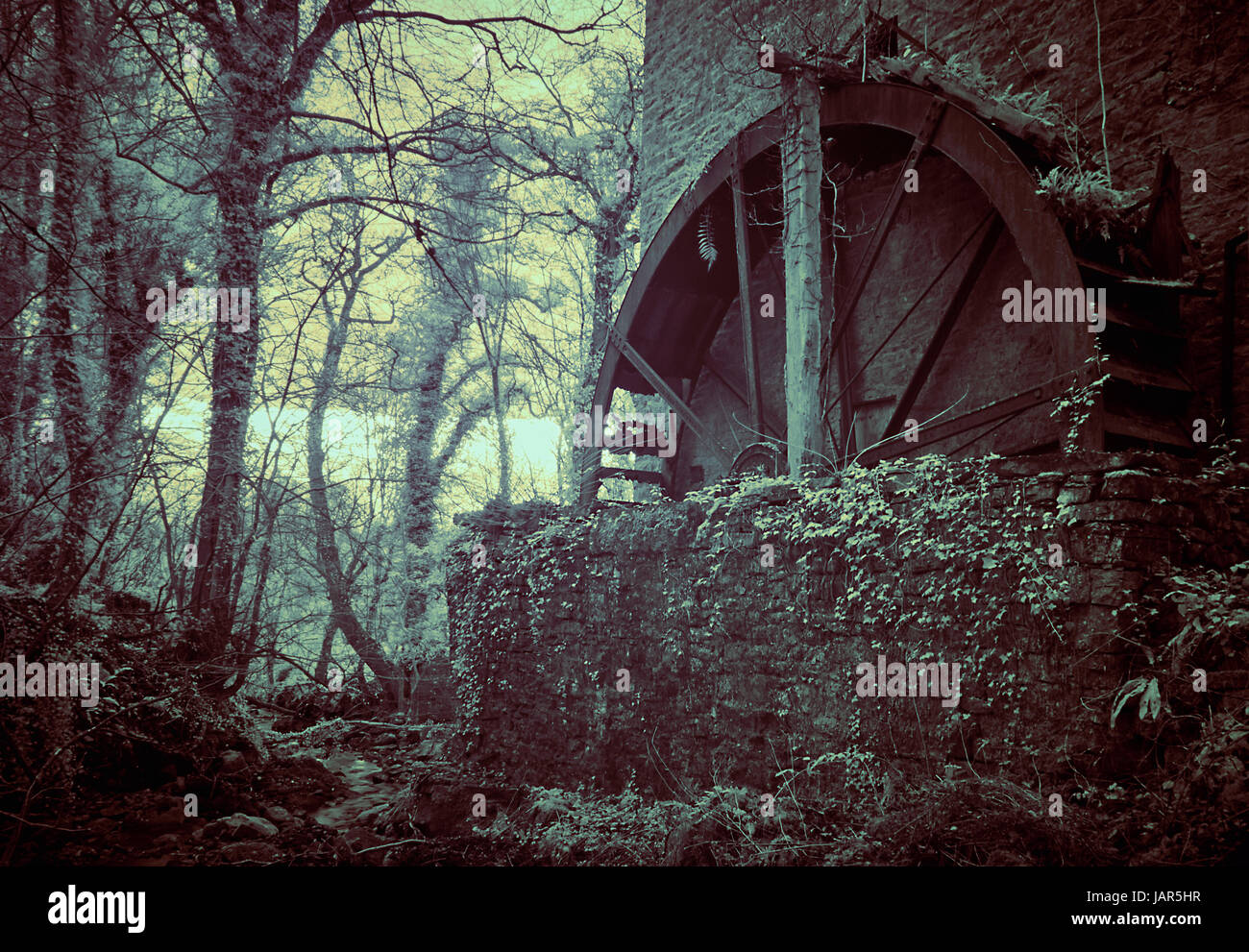 Infrared image of the old, rusting water mill at Wensley, near Leyburn in the Yorkshire Dales. Stock Photo