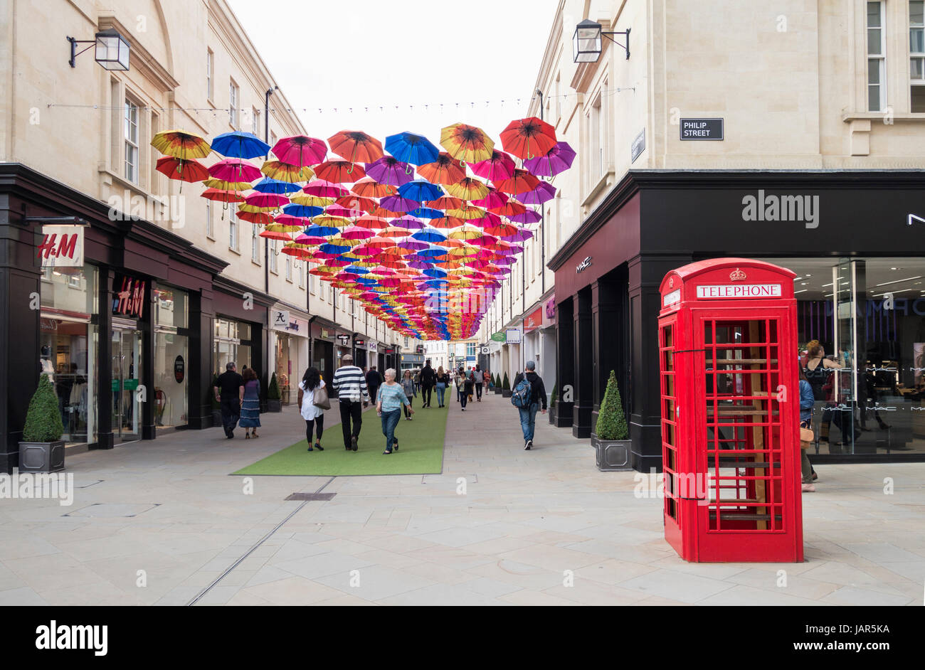 Umbrellas suspended in the air above shoppers in Southgate Shopping Centre, Bath, England, UK Stock Photo