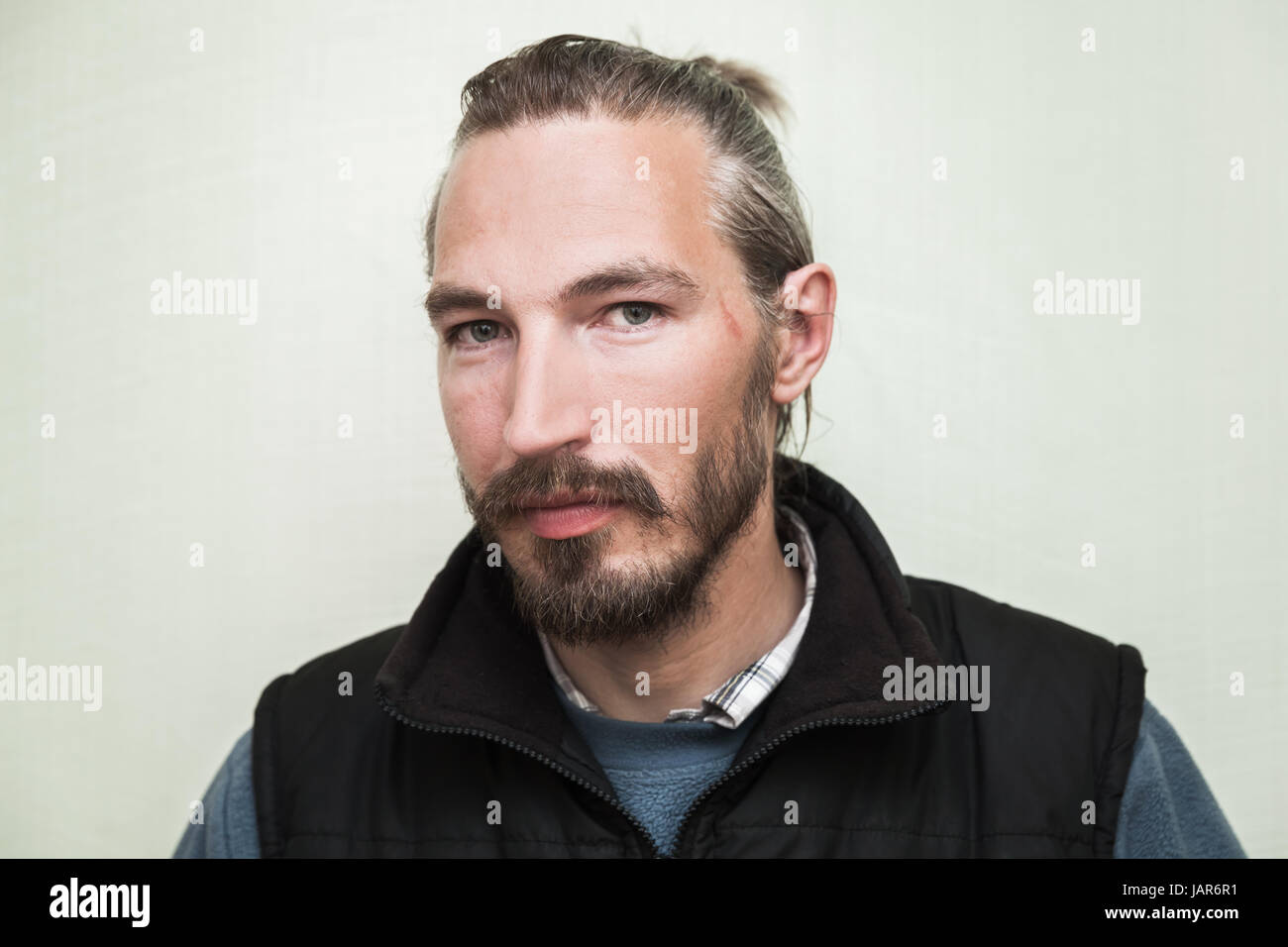 Close Up Portrait Of Young Bearded Asian Man Above Light Green