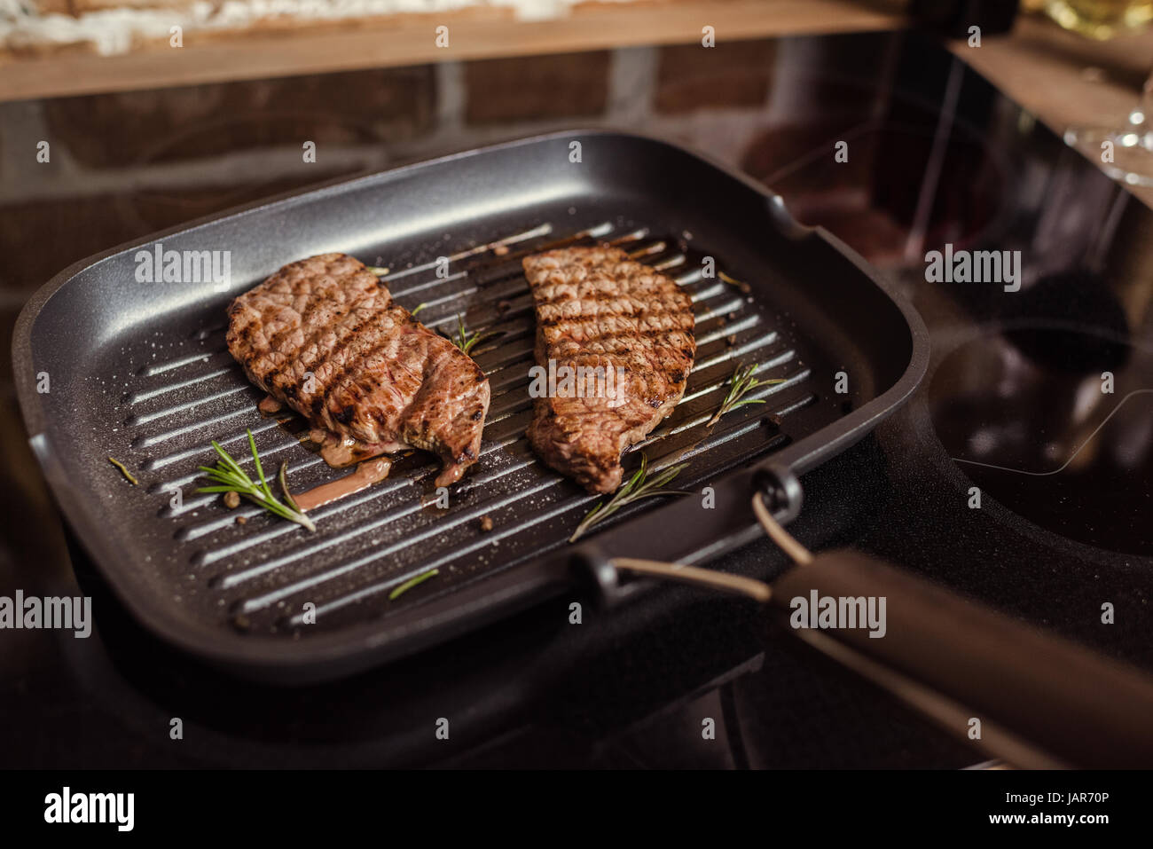 Grilled steaks in frying pan Stock Photo Alamy