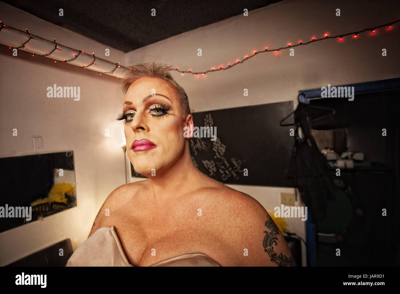 Serious Drag Queen With Bra And Tattoo In Dressing Room