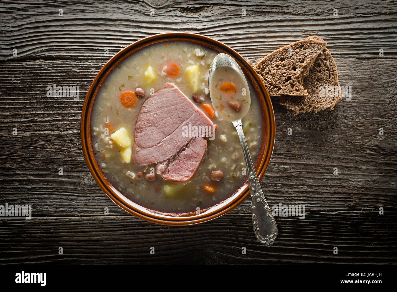 Traditional Slovenian barley soup - ricet with bread Stock Photo