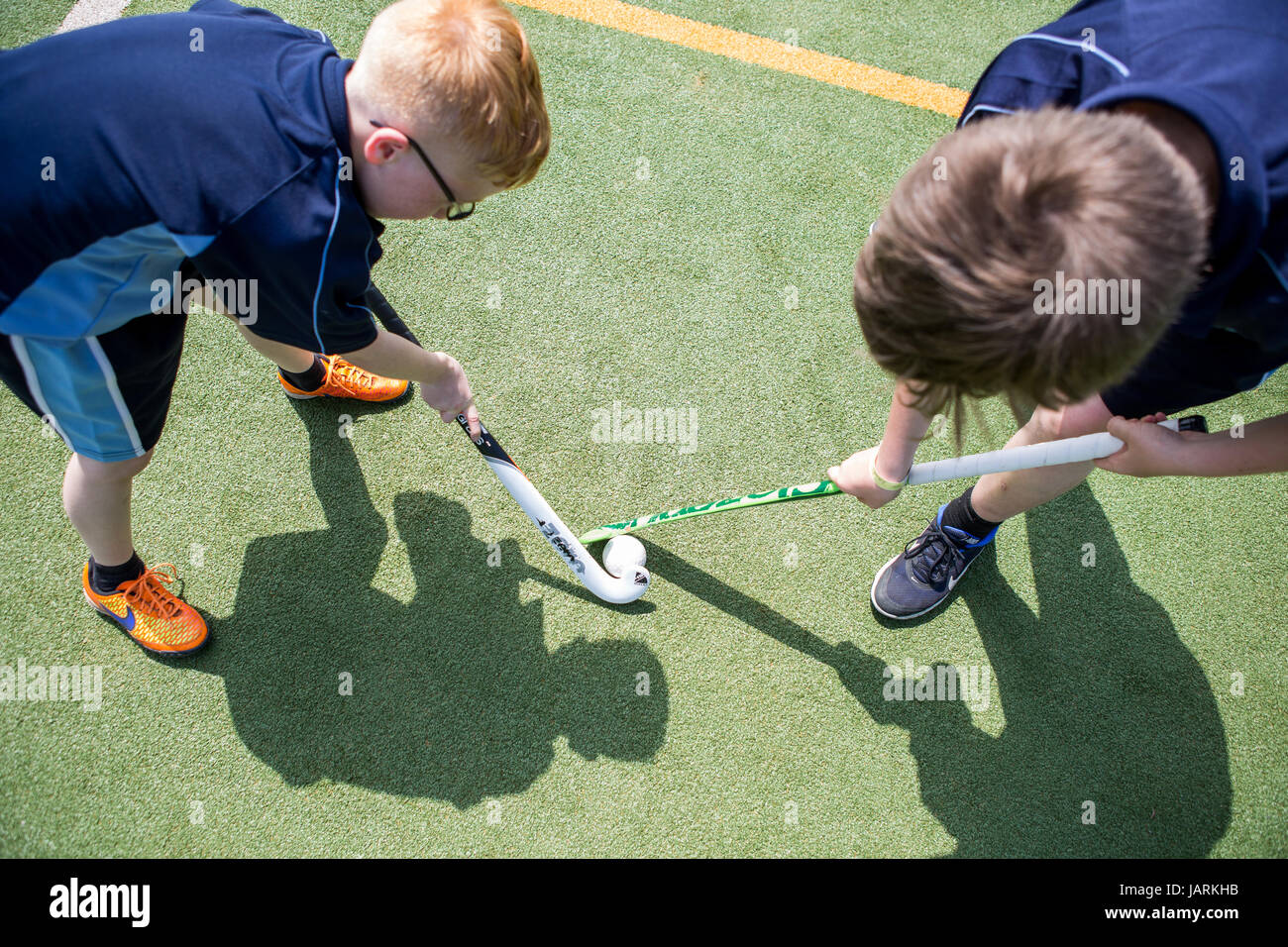 PE lessoplaying hockey shot from above Stock Photo