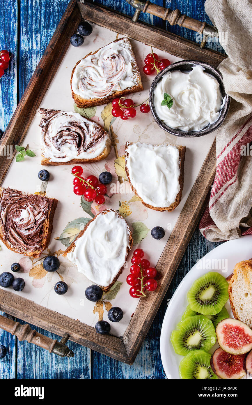 Variety of dessert sandwiches with berries and cream cheese and ...
