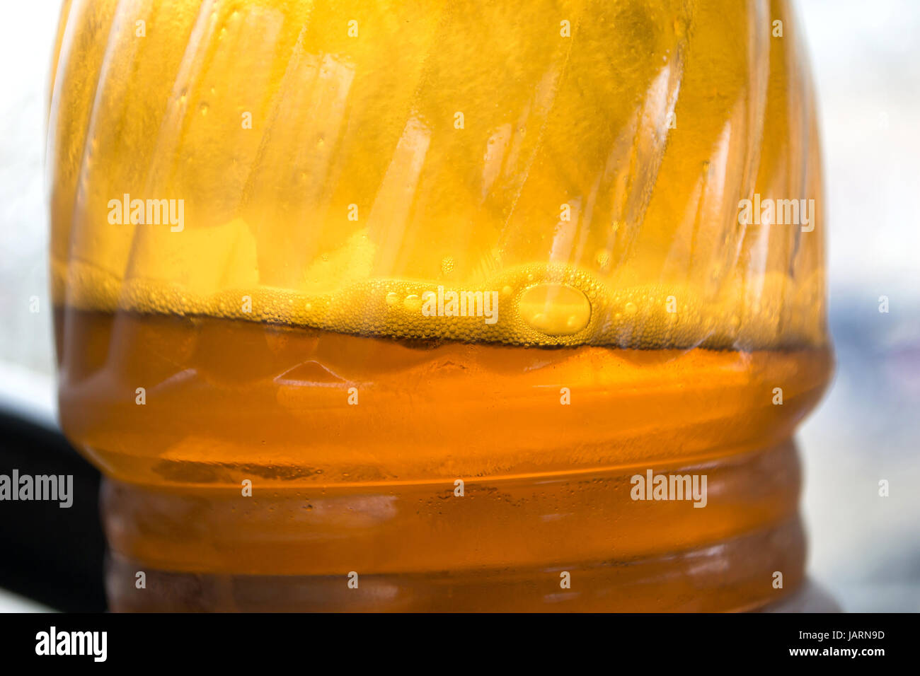Foam and bubbles in a bottle of beer Stock Photo