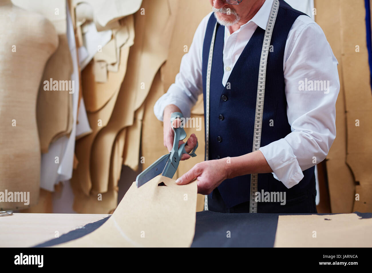 Mature Tailor Making Garments in Atelier Studio Stock Photo