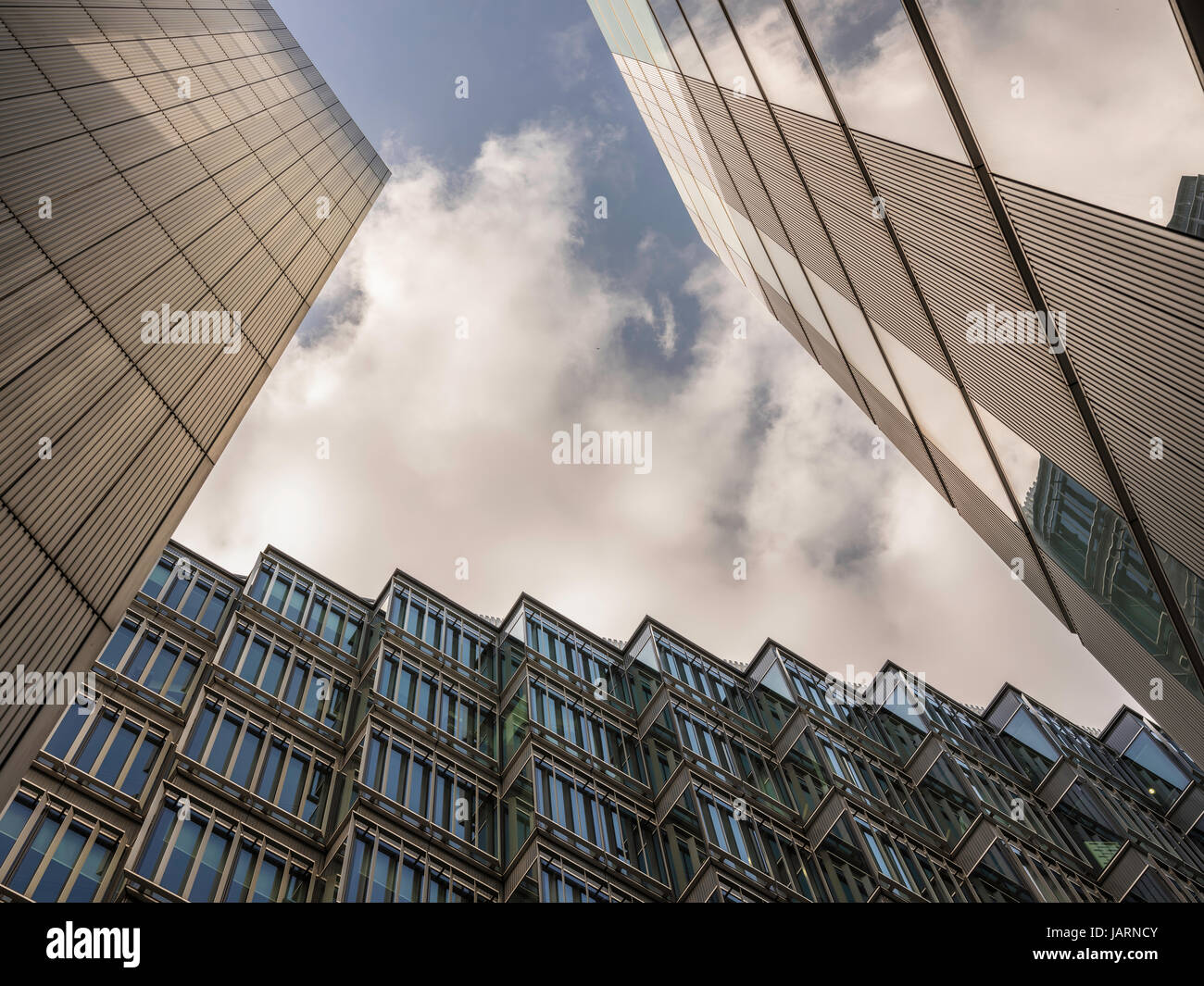 London-UK, April 13th, 2017: London Docklands skyscrapers. Low wide angle view of converging skyscrapers in the business district. Stock Photo