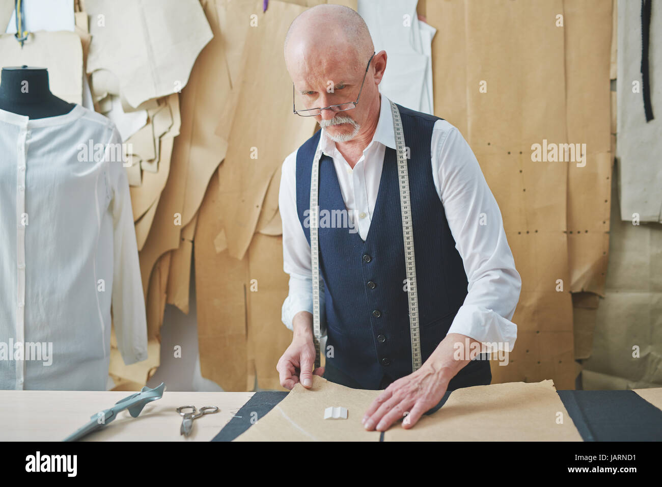 Senior Man Sewing Tailored Suit Stock Photo