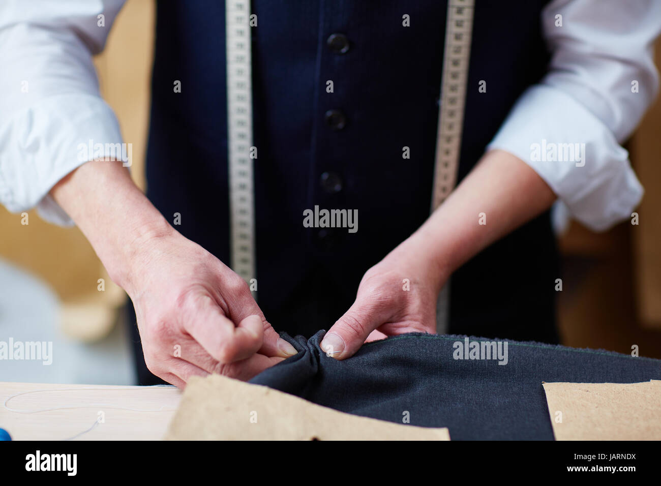 Tailor Making Custom Clothes in Atelier Stock Photo