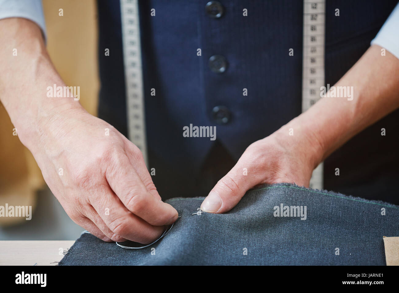 Experienced Tailor Stitching Seams on Custom Garment Stock Photo