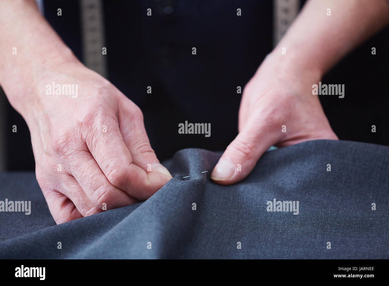 Tailor Sewing Clothes in Atelier Stock Photo
