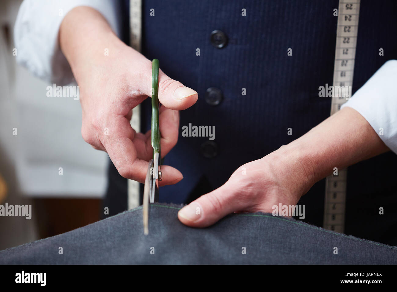 Tailor Cutting Cloth in Atelier Stock Photo