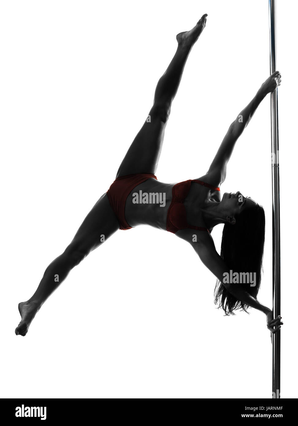 one caucasian woman pole dancer dancing in silhouette studio isolated on white background Stock Photo
