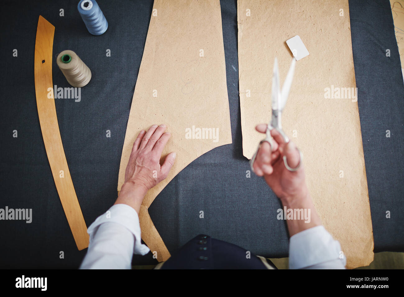 Top View: Tailor Working in Atelier Stock Photo