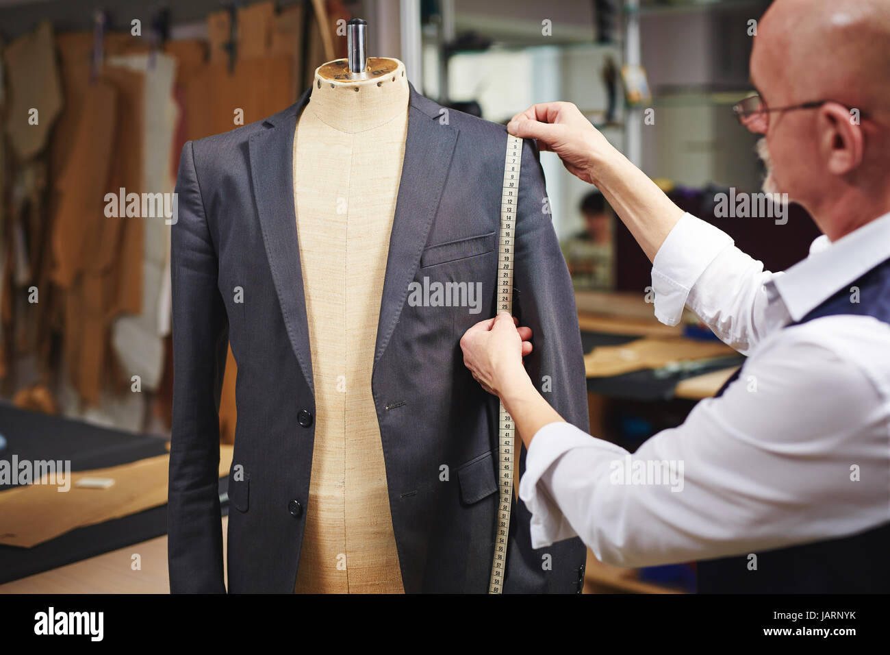 Tailor Measuring Custom Suit in Atelier Stock Photo