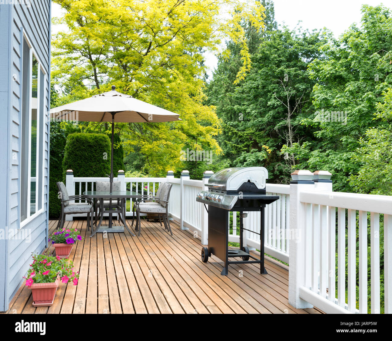 Clean outdoor cedar wooden deck and patio of home during daytime Stock Photo