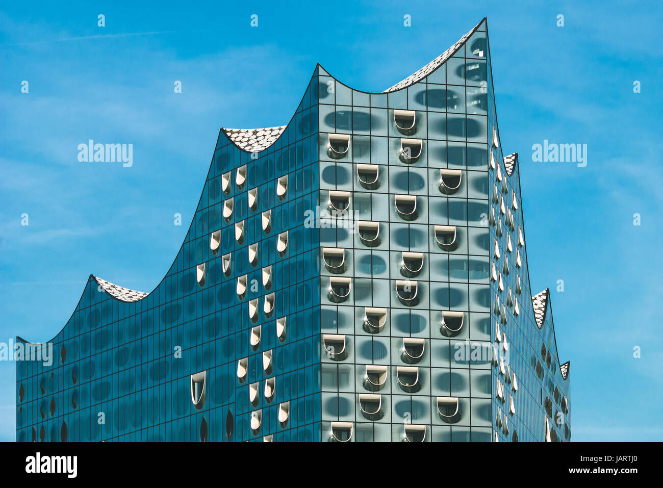 Hamburg, Germany - May 28, 2017: Top shape of Elbphilharmonie with white windows and some white clouds in sky, Hamburg, Germany. Stock Photo