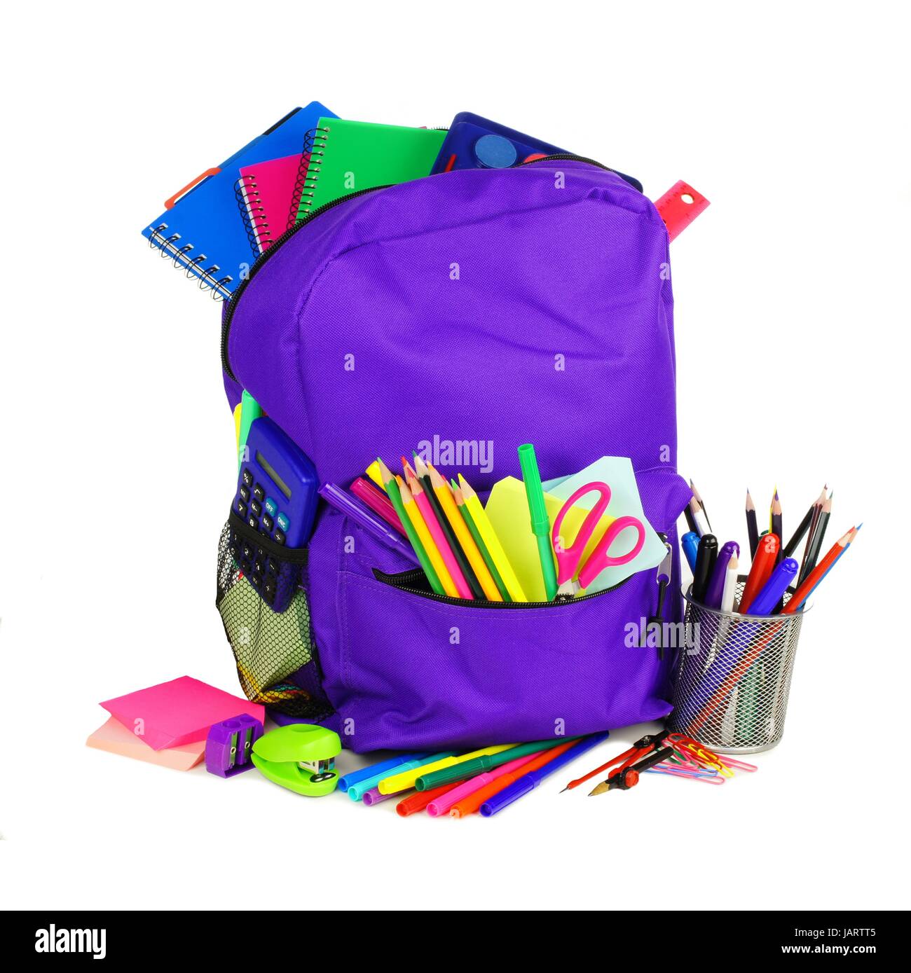 Purple backpack full of school supplies over a white background Stock Photo