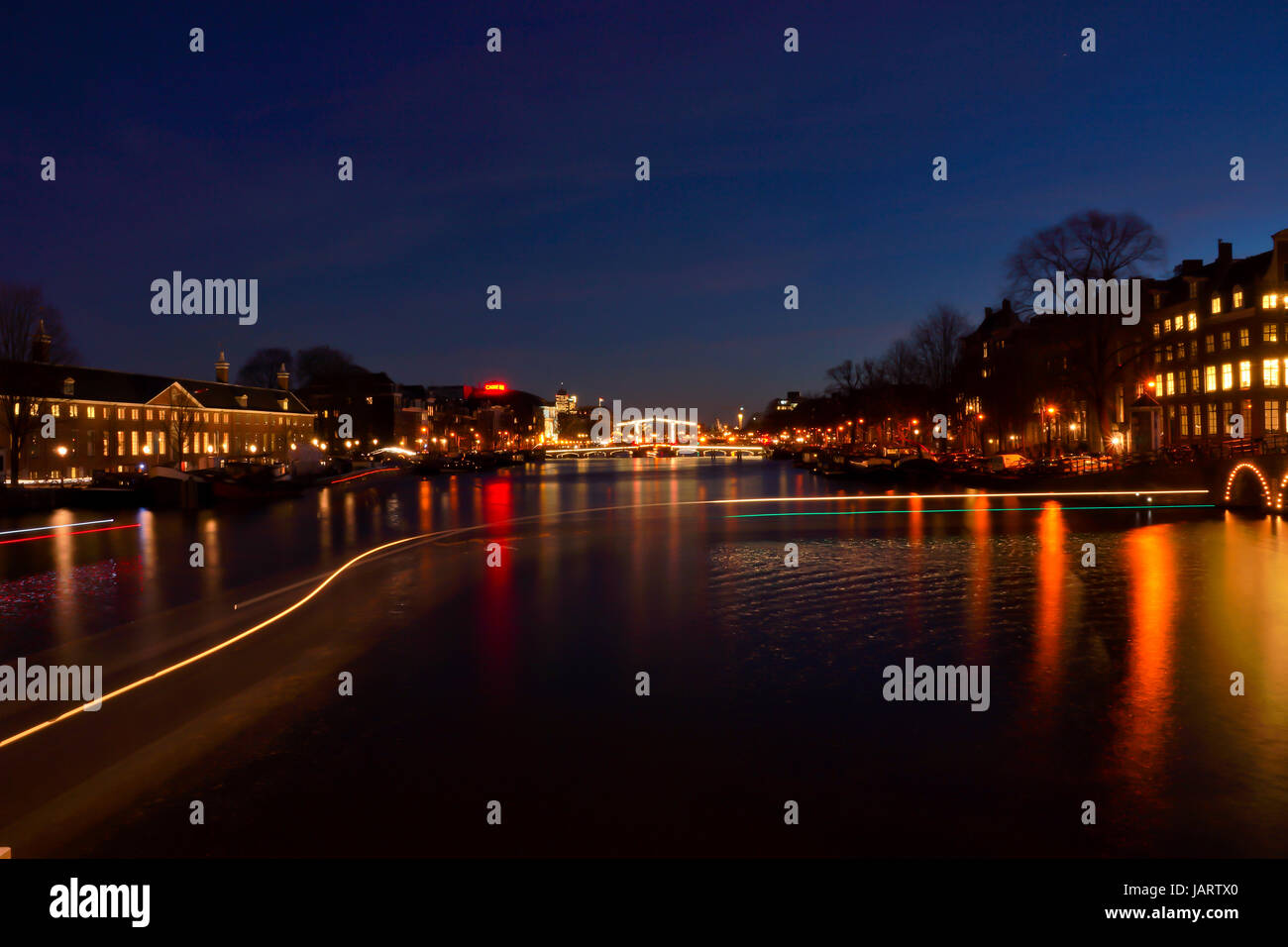 Trails of light on one of the major canals in Amsterdam at night Stock Photo