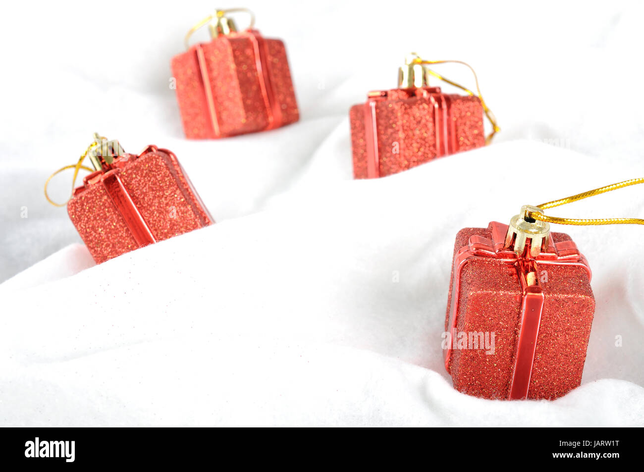 Red gift box on snow white background Stock Photo - Alamy