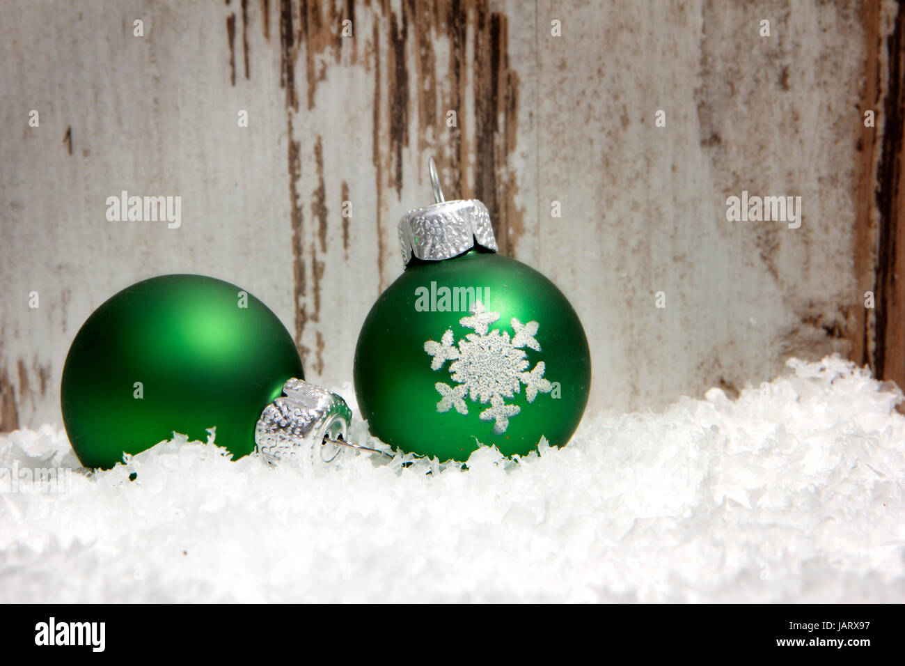 Weihnachten, Dekoration mit Holzhintergrund, Schnee, Weihnachtskugeln grün Stock Photo